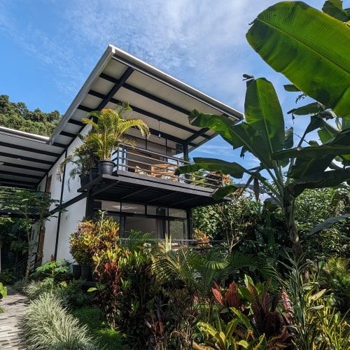 Modern bungalow of Las Terrazas de Dana among tropical gardens